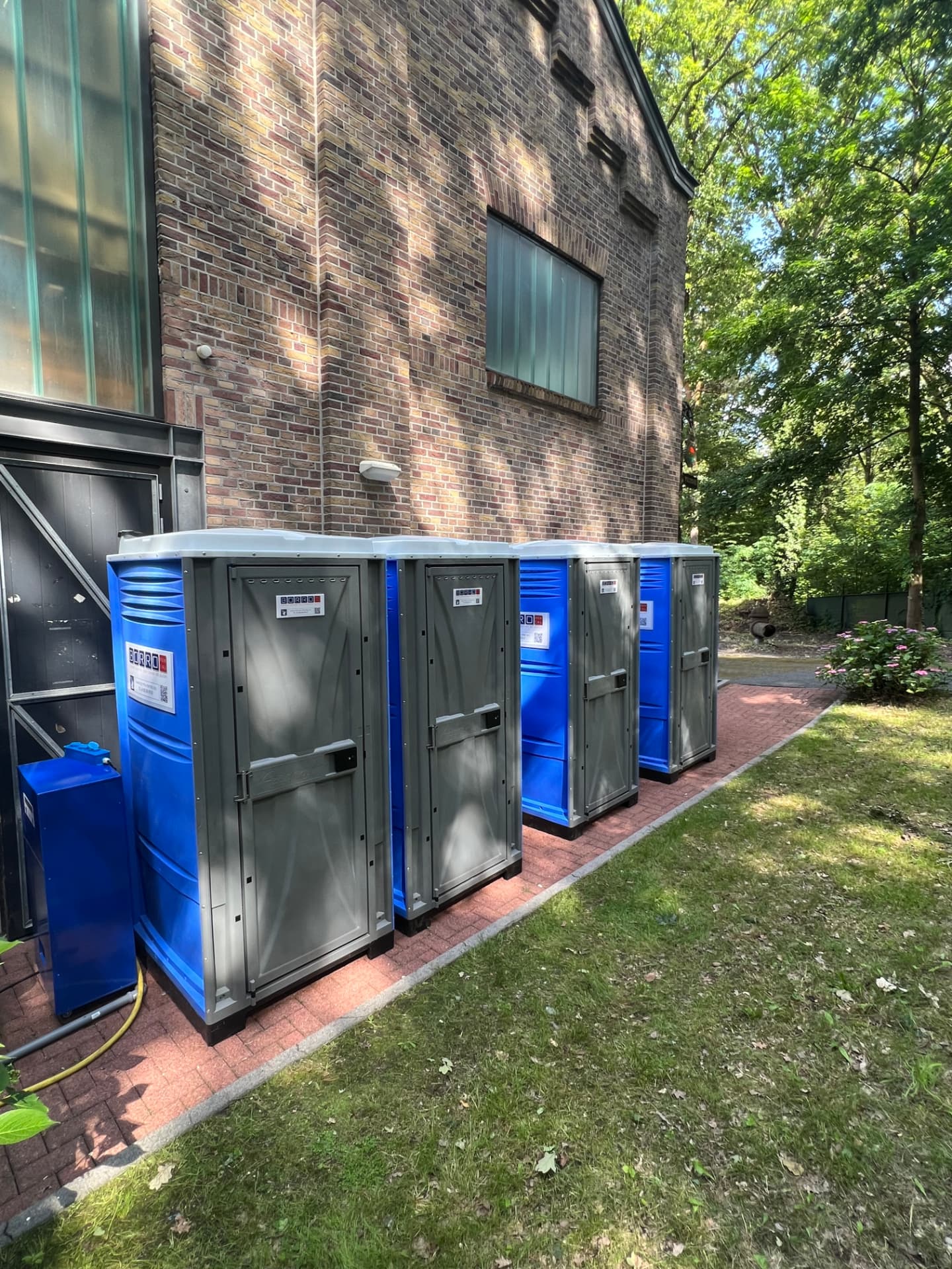 Row of mobile shower cabins at a school camp